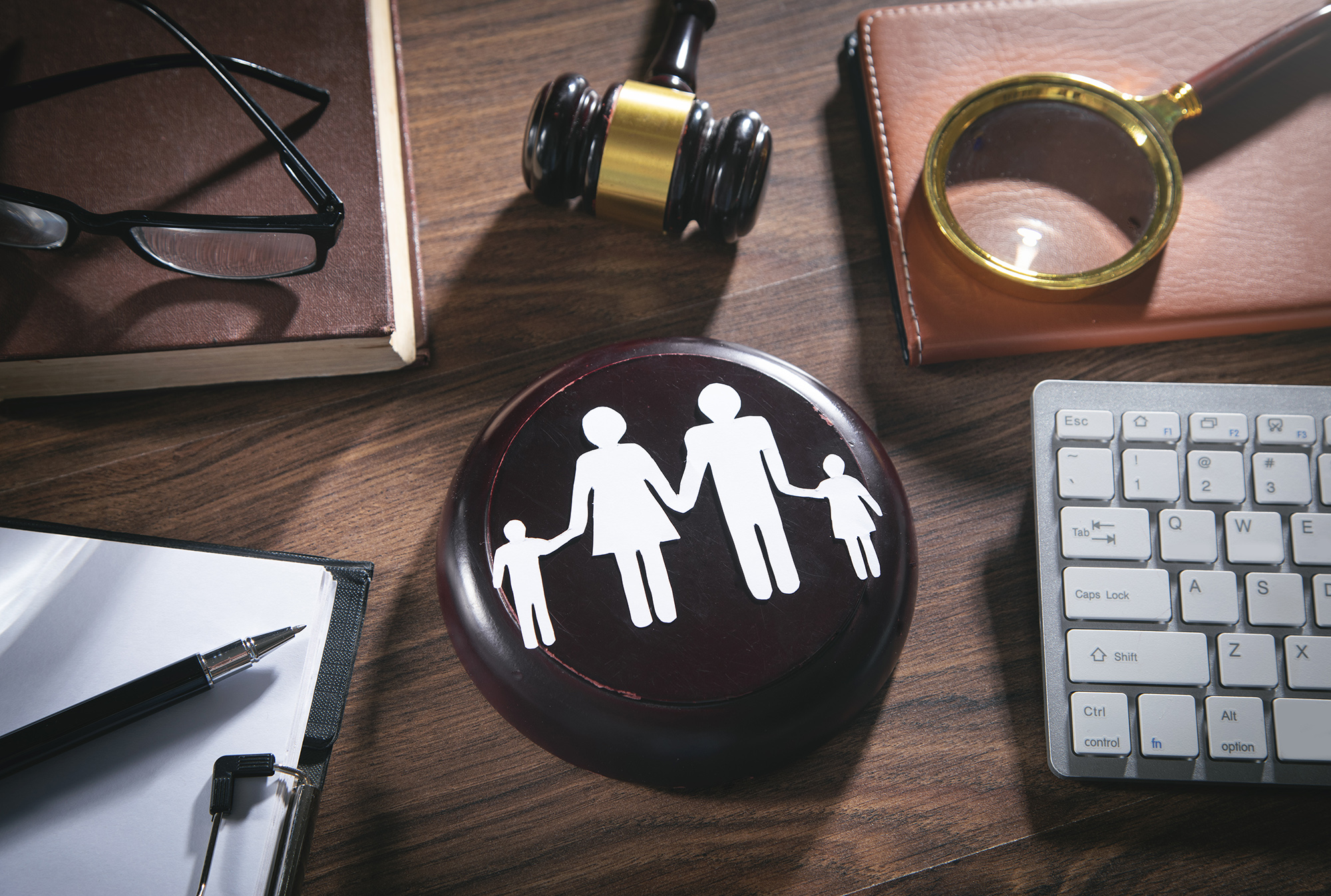 Paper cut family, judge gavel, book and other objects. Family Law